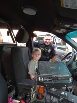 Lemoore continues its Neighborhood Watch tradition with National Night Out This youngster gets a birds-eye view of a Lemoore police vehicle.